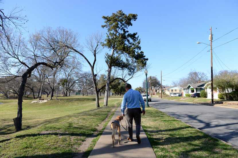 Dustin Deweerd, walks his 3-year-old Labrador service dog Gunny, at Lake Cliff Park on March...