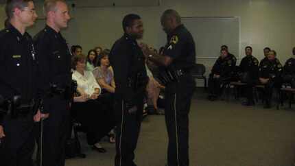 Officer Bryson Brown's father, Dwayne Brown, pinned his badge on at a ceremony 10 years ago....