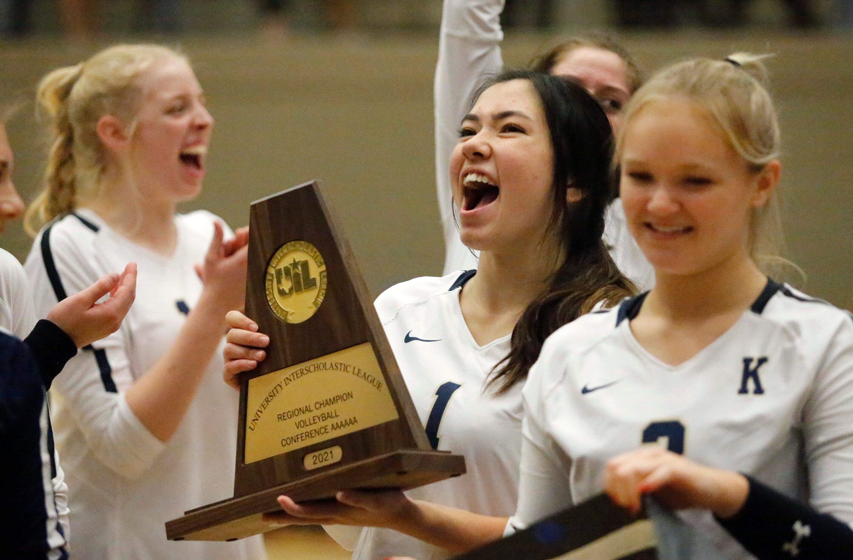 Keller High School setter Sophia Odle (1) holds the regional trophy as Keller High School...