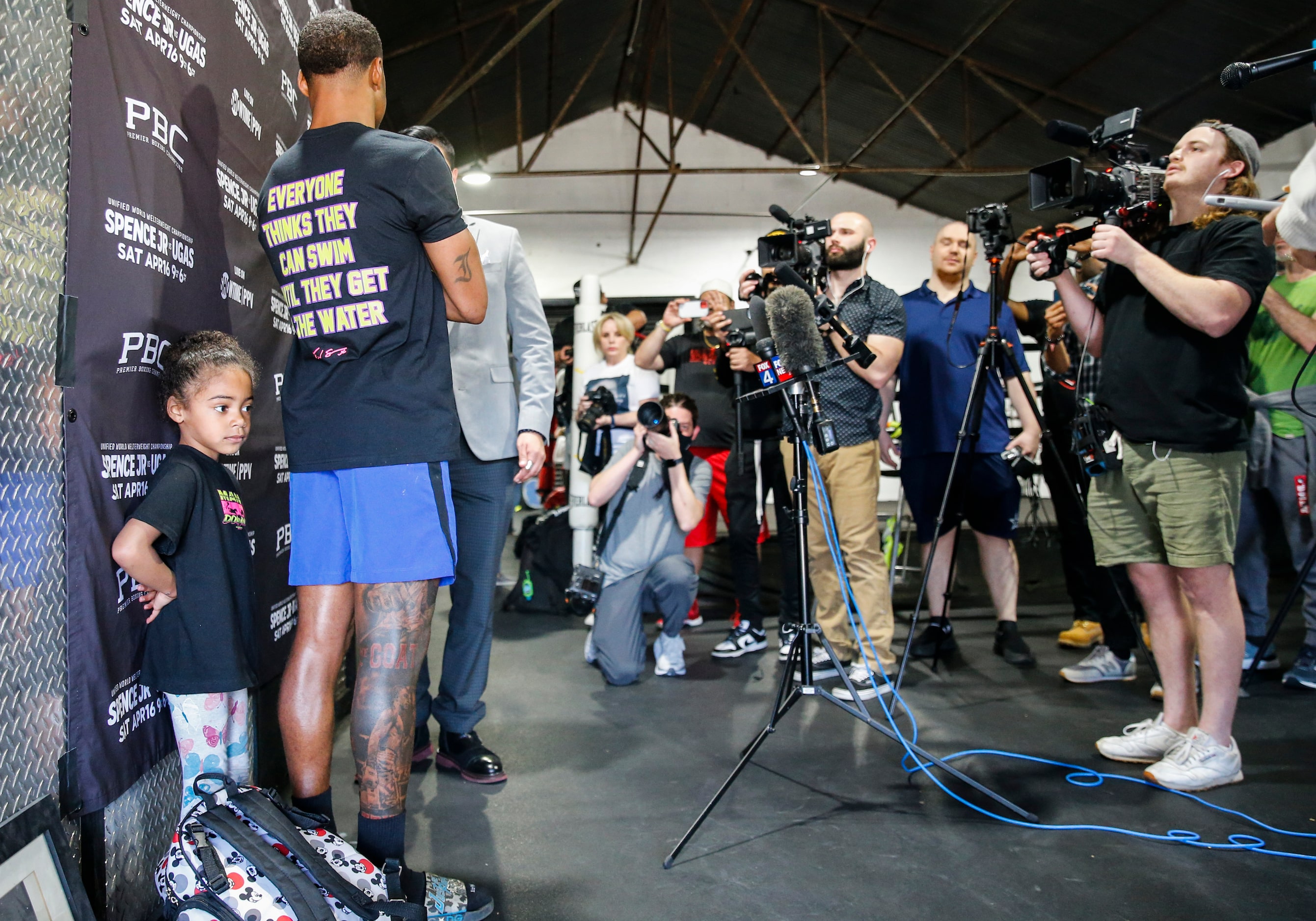 Ivy Spence, left, daughter of Errol Spence Jr. of Desoto watches as his father speaks during...