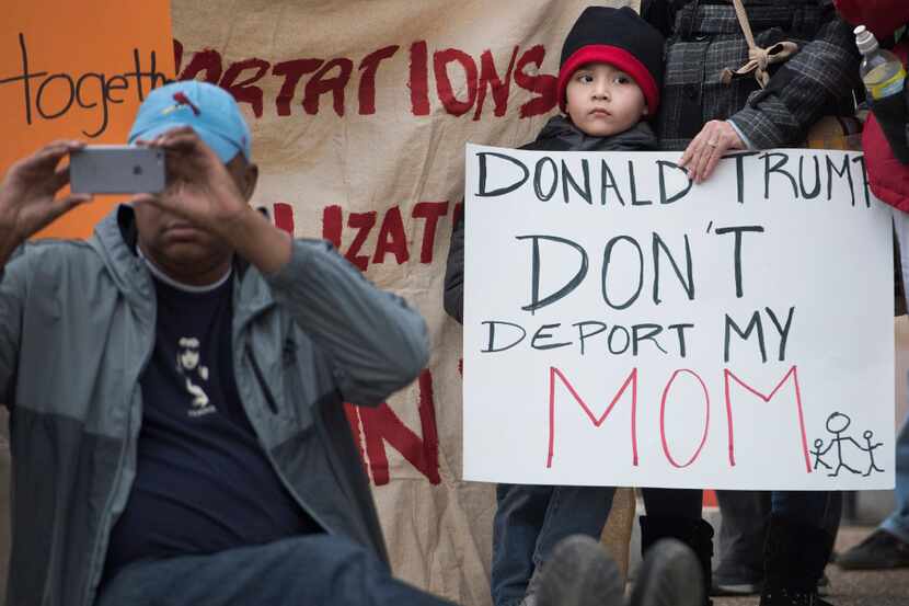 A young boy with his mother attend a rally in front of the White House in February organized...