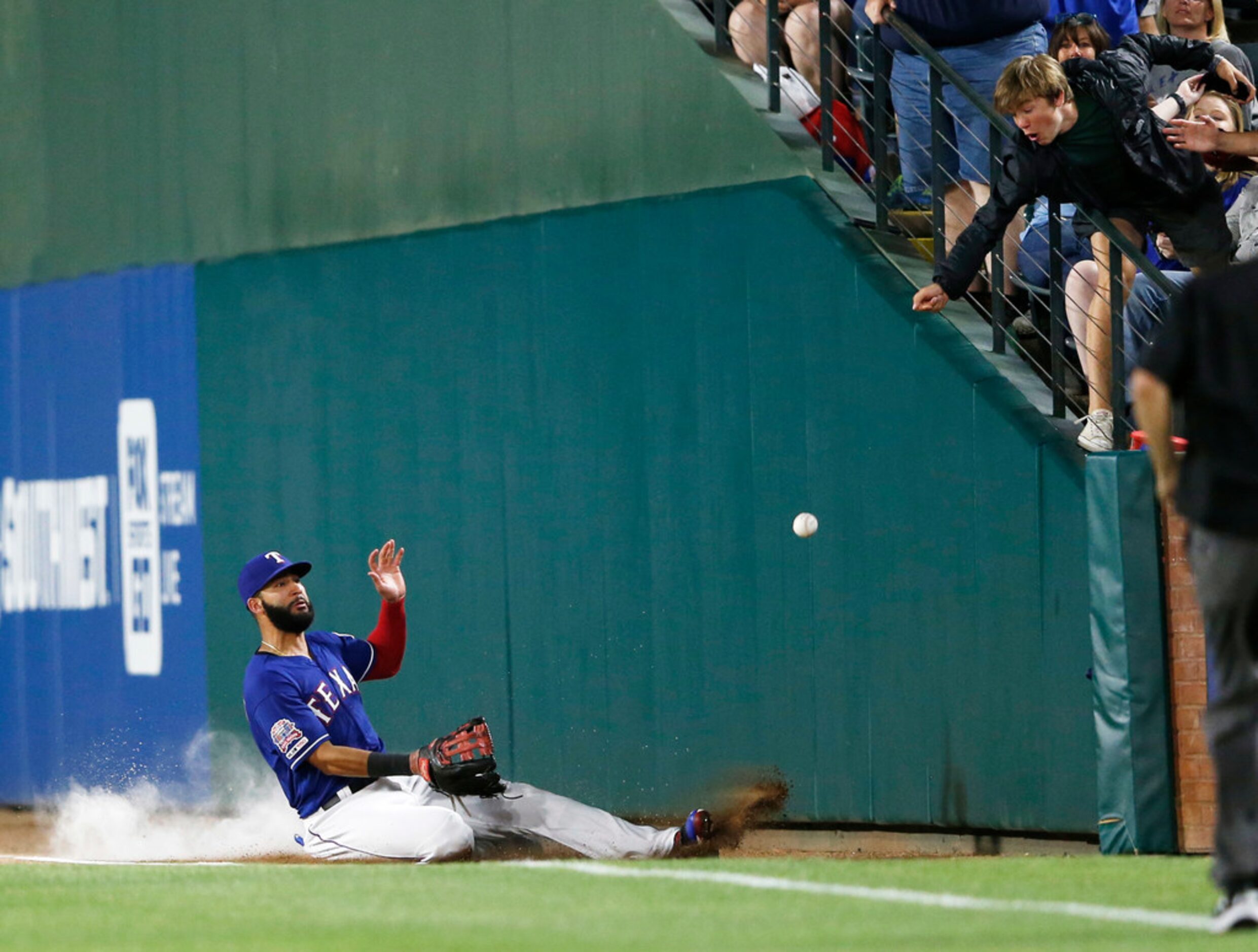 Texas Rangers right fielder Nomar Mazara (30) slides in an attempt to catch a foul ball...