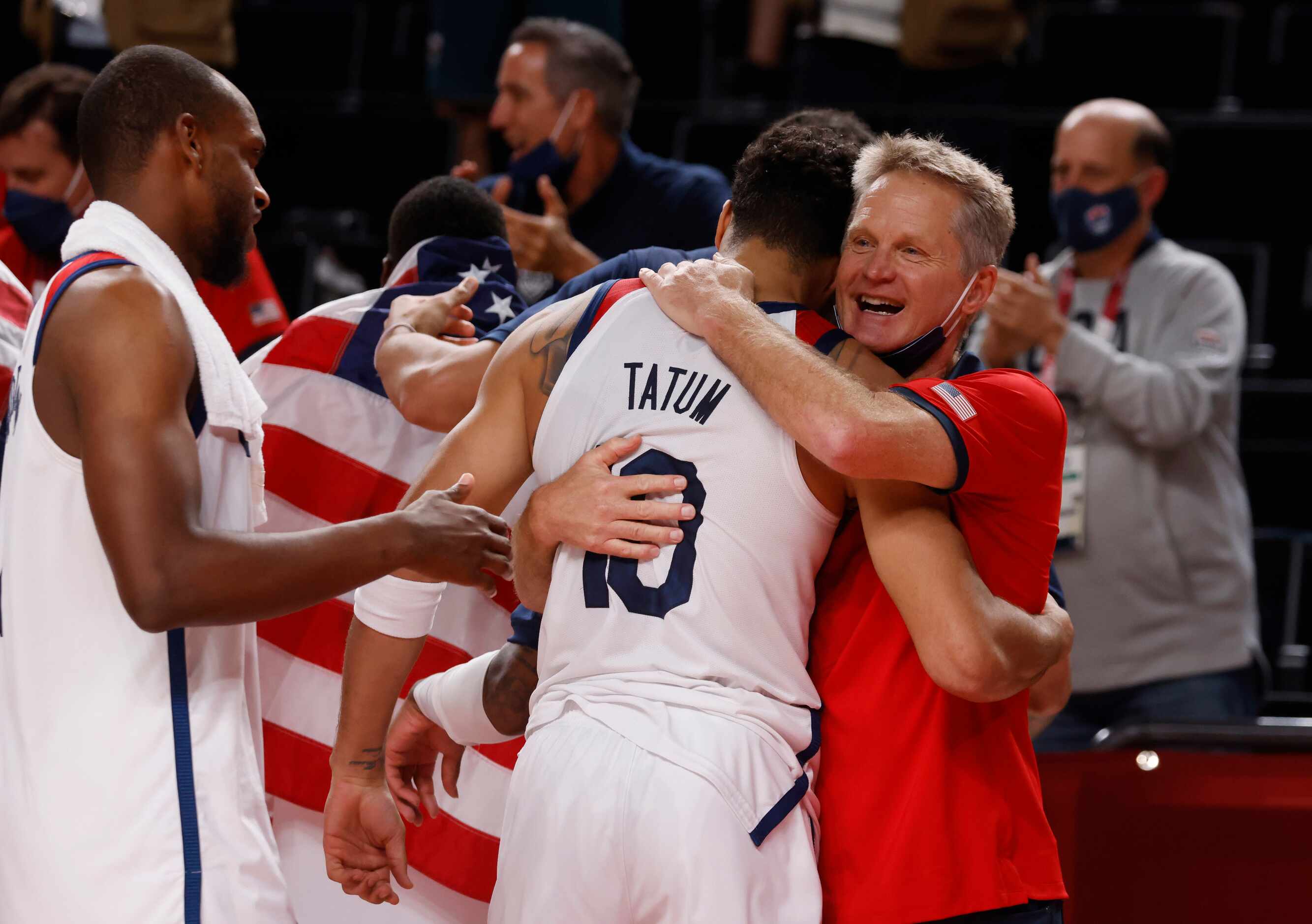 USA assistant coach Steve Kerr hugs Jayson Tatum (10) after they defeated France in the gold...