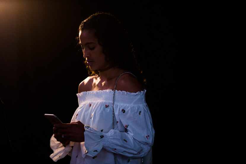 Dallas Wings player Skylar Diggins checks her phone during the Dallas Wings WNBA Draft...