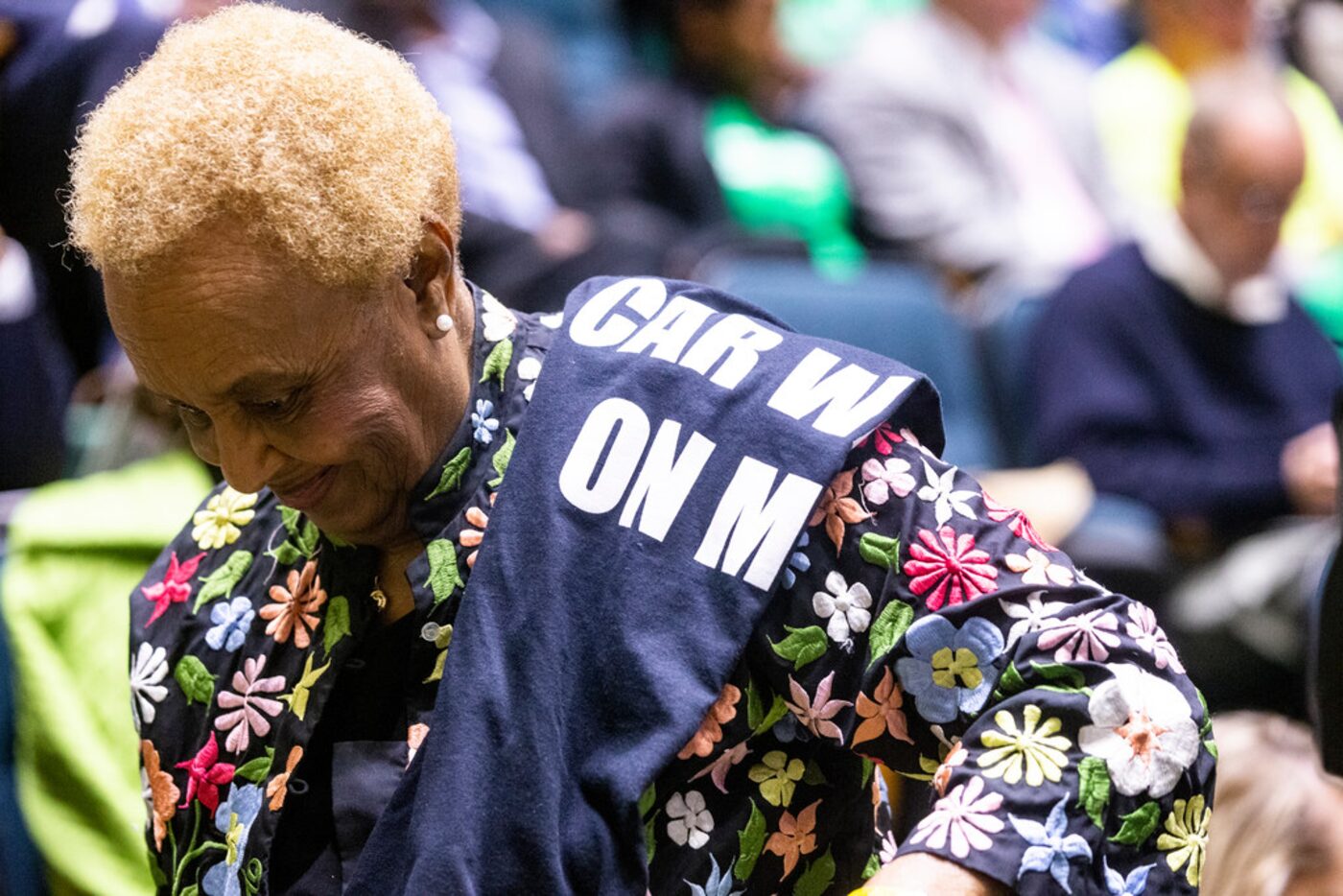 Willie Colman walks back to her seat after speaking against Jim's Car Wash to the council...