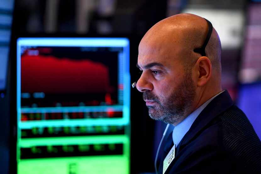 Traders work during the opening bell at the New York Stock Exchange (NYSE) on February 28,...