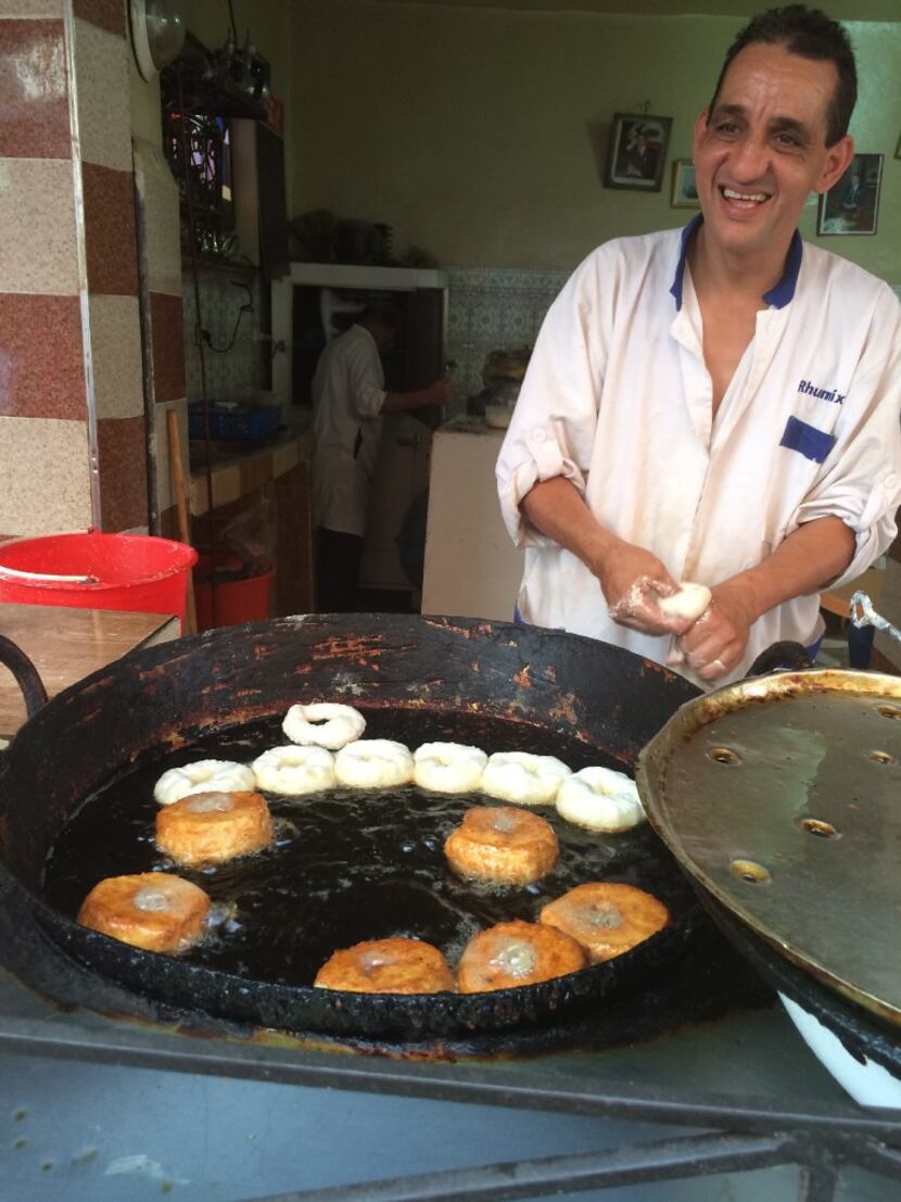 A street vendor fries up hundreds of fresh doughnuts morning until night in Marrakesh. 