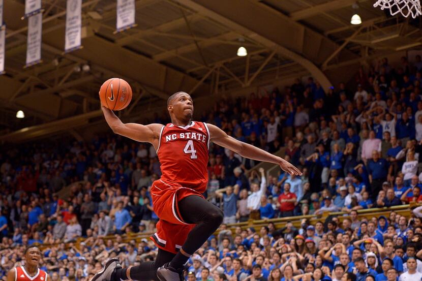DURHAM, NC - JANUARY 23:  Dennis Smith Jr. #4 of the North Carolina State Wolfpack drives in...