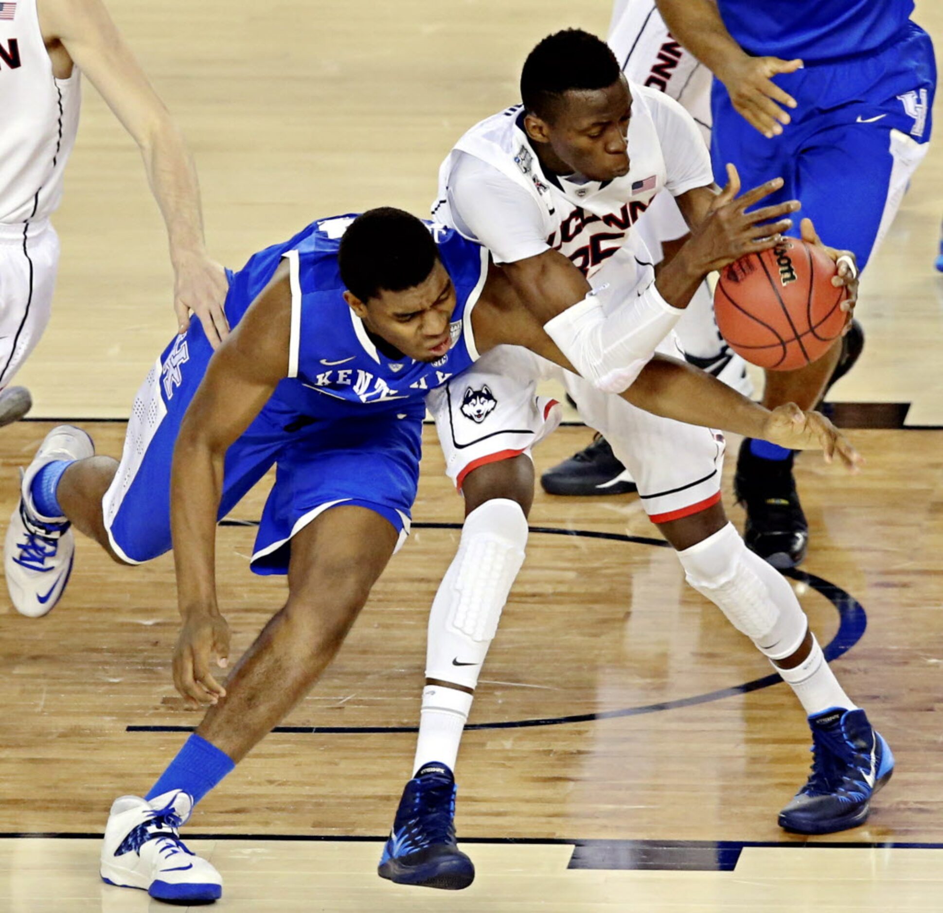 Kentucky Wildcats center Dakari Johnson (left) and Connecticut Huskies center Amida Brimah...