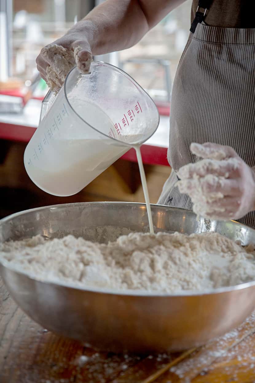 Chef Tim Byres adds buttermilk as he makes buttermilk biscuits at Chicken Scratch restaurant. 
