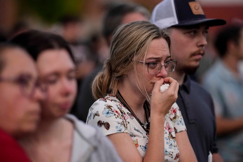 Mourners pray during a candlelight vigil for the slain students and teachers at Apalachee...