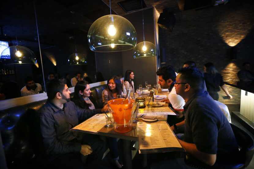 Friends celebrate a birthday in the Grotto Bar at the new Sfuzzi location, Saturday, January...