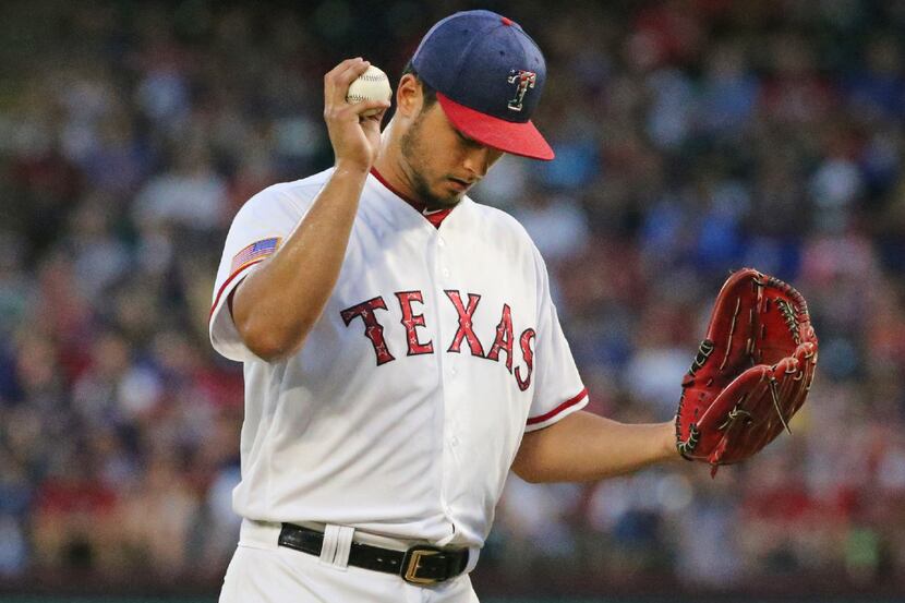 Texas Rangers starting pitcher Yu Darvish (11) reacts after giving up a run in the fourth...
