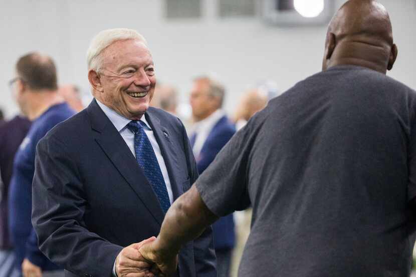 Cowboys owner Jerry Jones greets former player Charles Haley during a training camp practice...