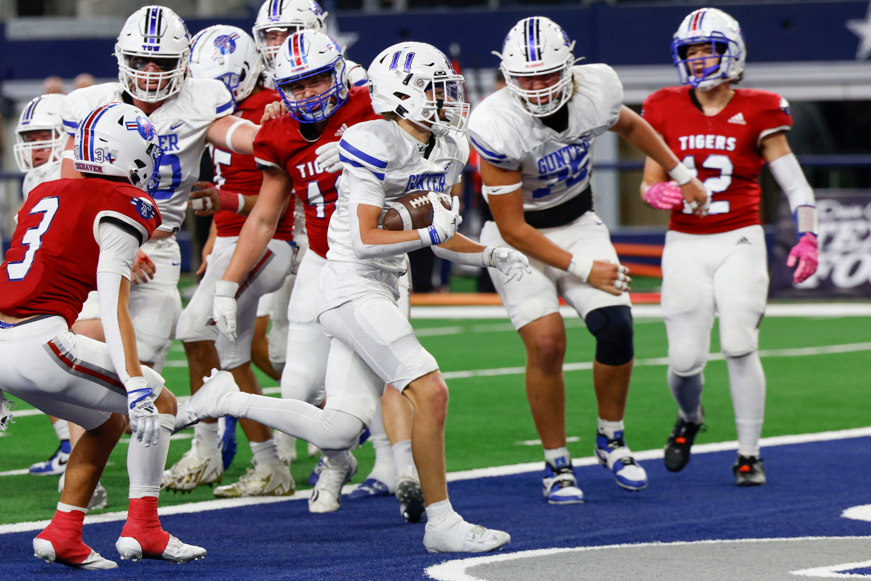 Gunter High’s Brock Boddle (11) carries the ball to the end zone for a touchdown against El...