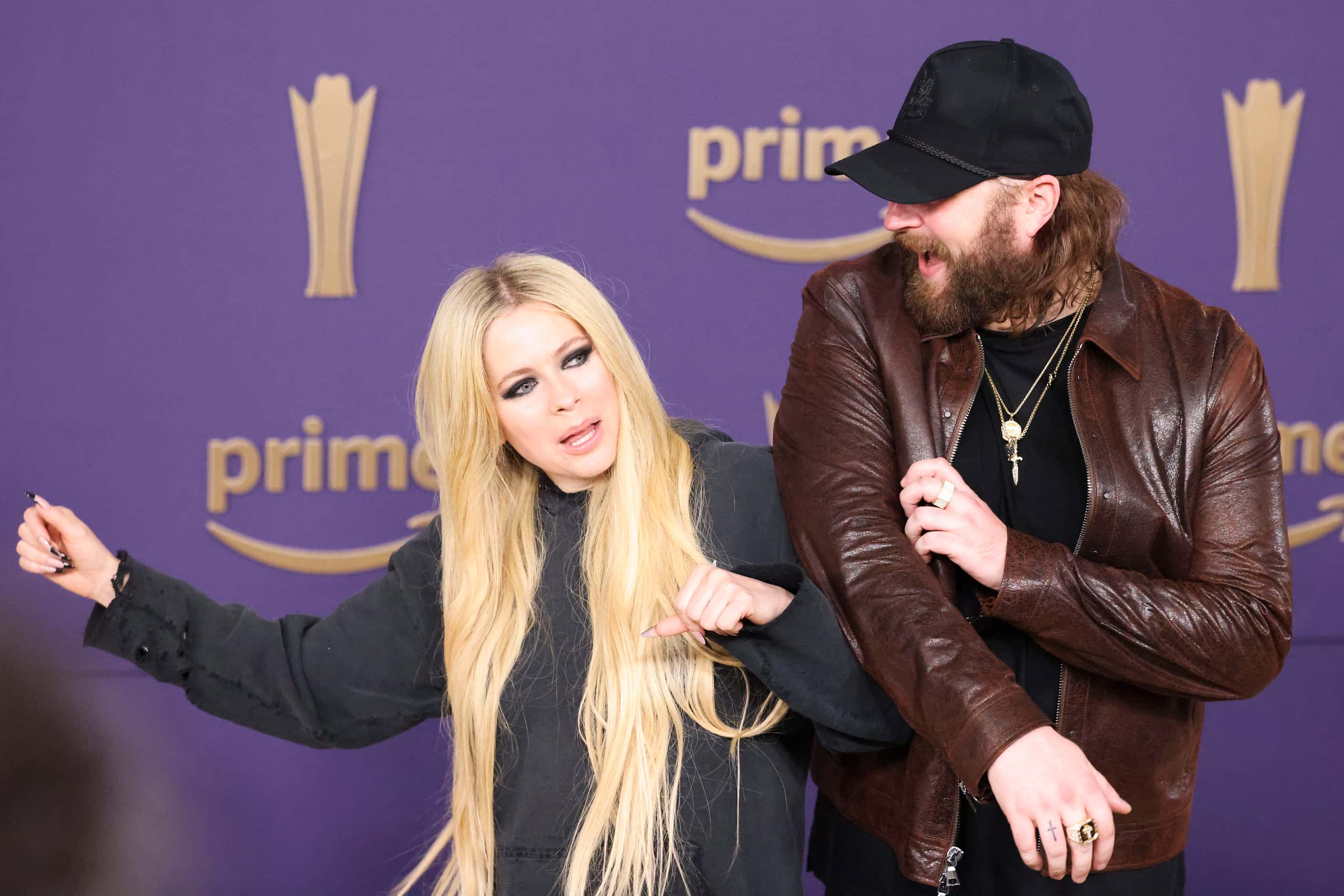 Avril Lavigne and Nate Smith arrive at the 59th Academy of Country Music Awards red carpet...