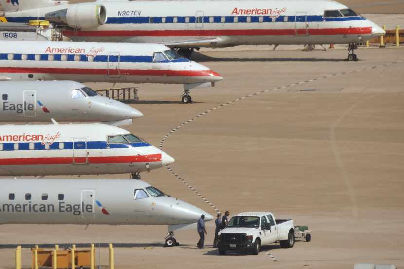 A line of American Eagle airplanes at DFW International Airport in Irving Friday,  July 31,...