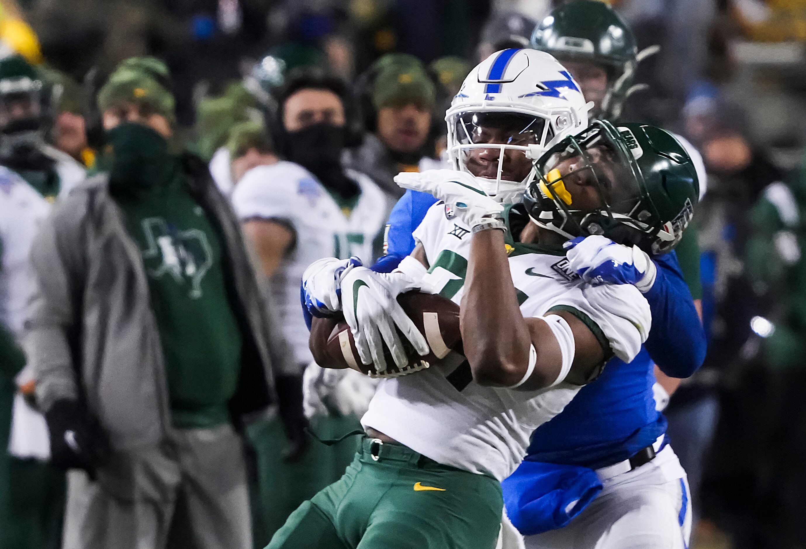 Baylor wide receiver Josh Cameron (34) is brought down by Air Force safety Trey Taylor (7)...