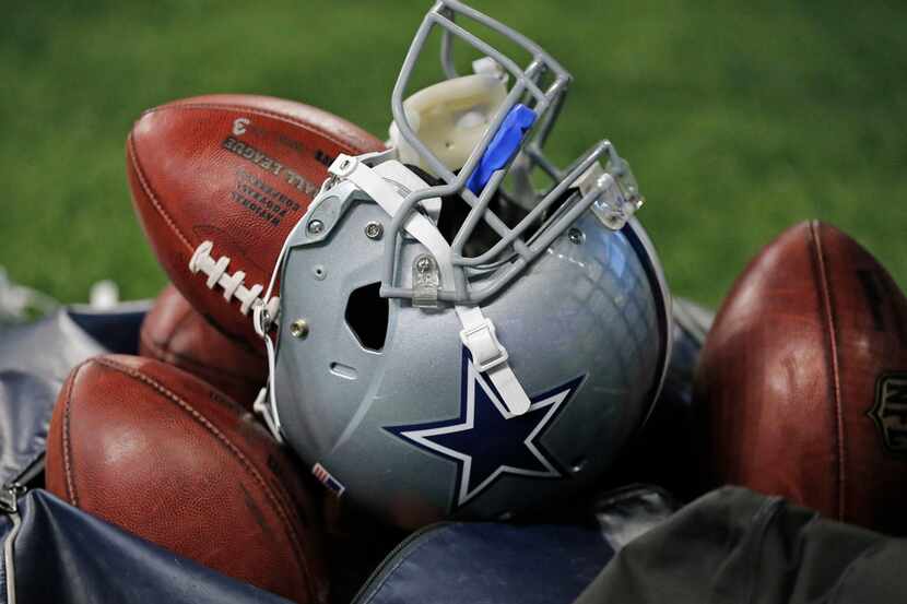 A Dallas Cowboys helmet sits on the top of a bag of footballs at the Dallas Cowboys vs. the...
