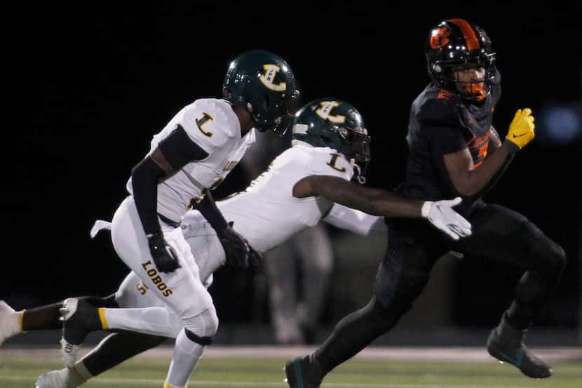 Lancaster running back Kewan Lacy (2), right, pulls away from the defensive pursuit of a...