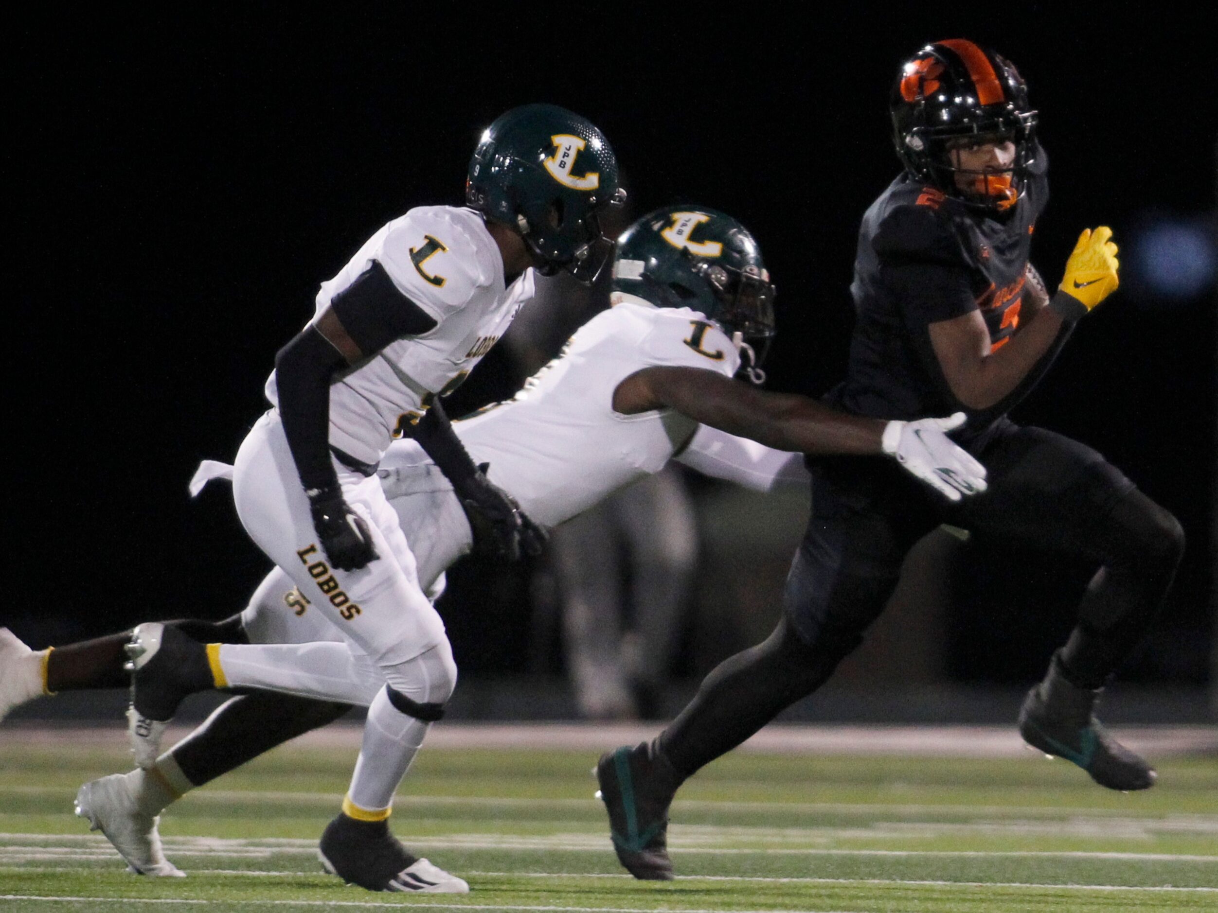 Lancaster running back Kewan Lacy (2), right, pulls away from the defensive pursuit of a...