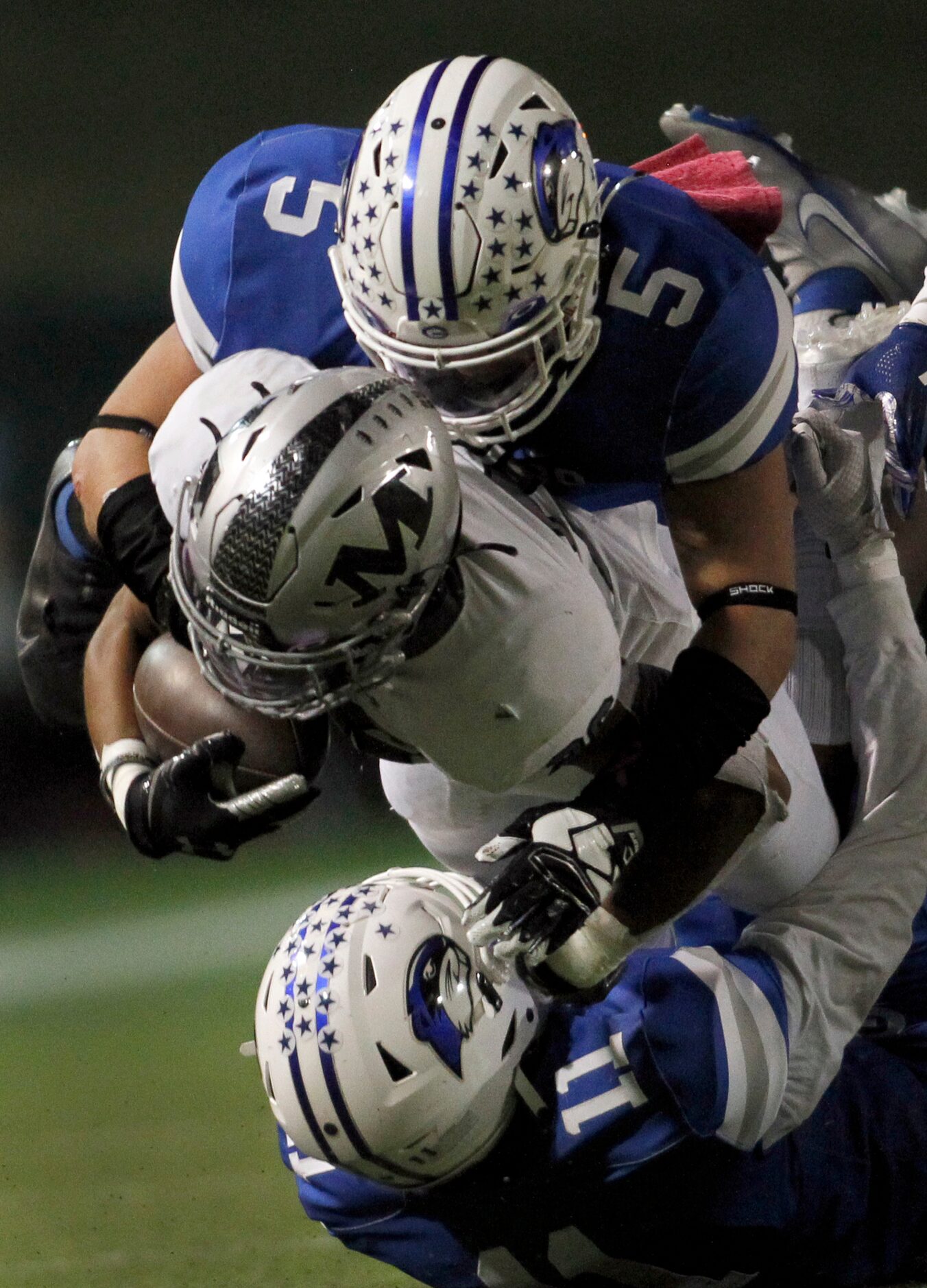 Arlington Martin running back Sergio Snider (26), center, is sandwiched by Grand Prairie...