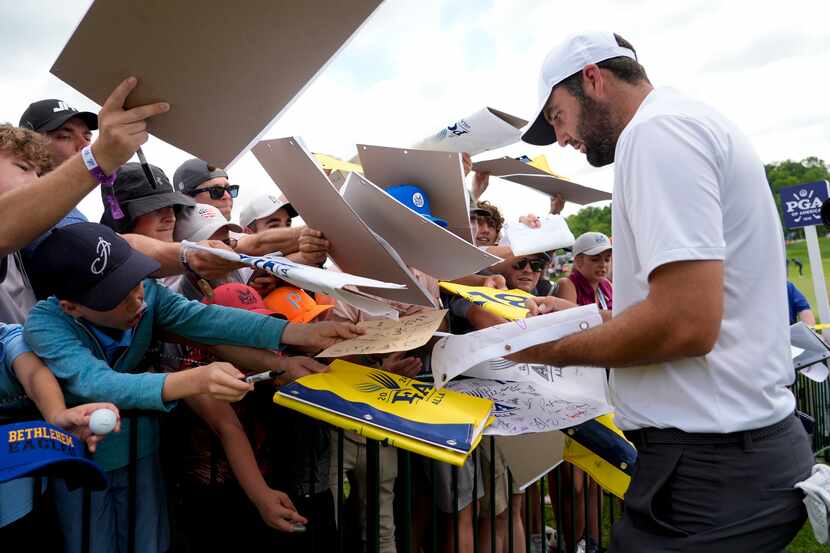 Scottie Scheffler signs autographs after a practice round for the PGA Championship golf...