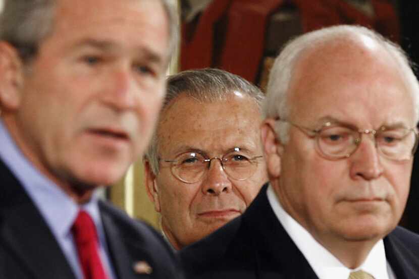 Secretary of Defense Donald Rumsfeld (center) and Vice President Dick Cheney listen as...