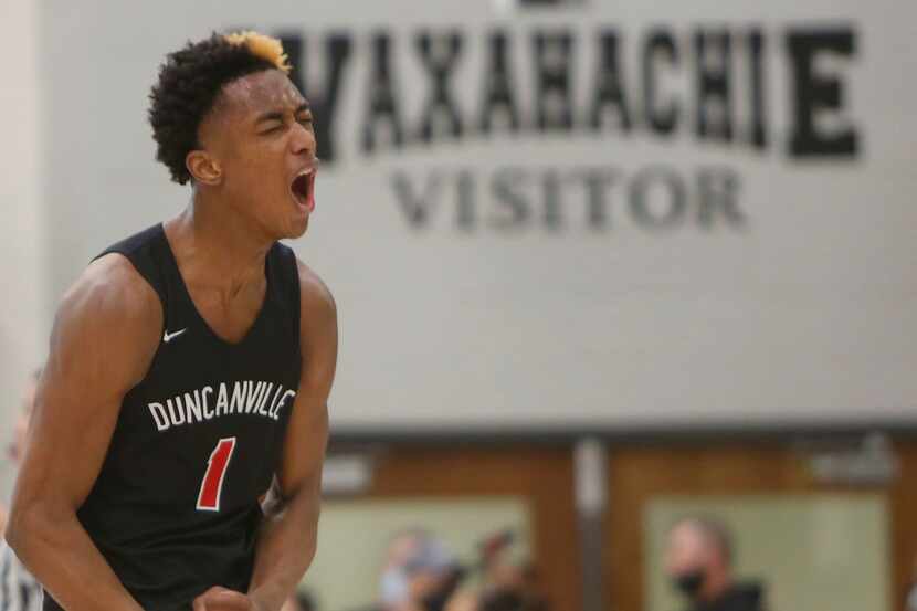 Duncanville's Ronald Holland lets out a yell after he scored which led to a called timeout...