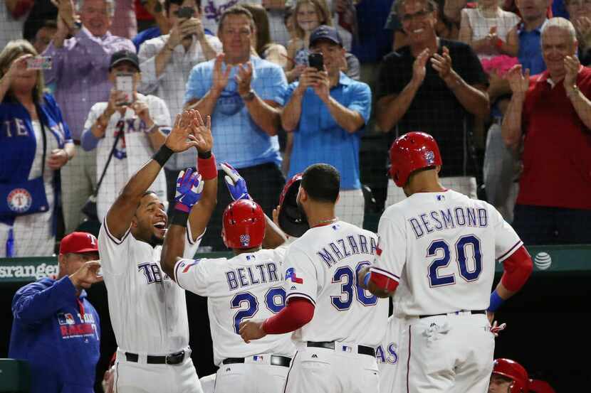 Texas Rangers shortstop Elvis Andrus (1) celebrates with third baseman Adrian Beltre (29),...