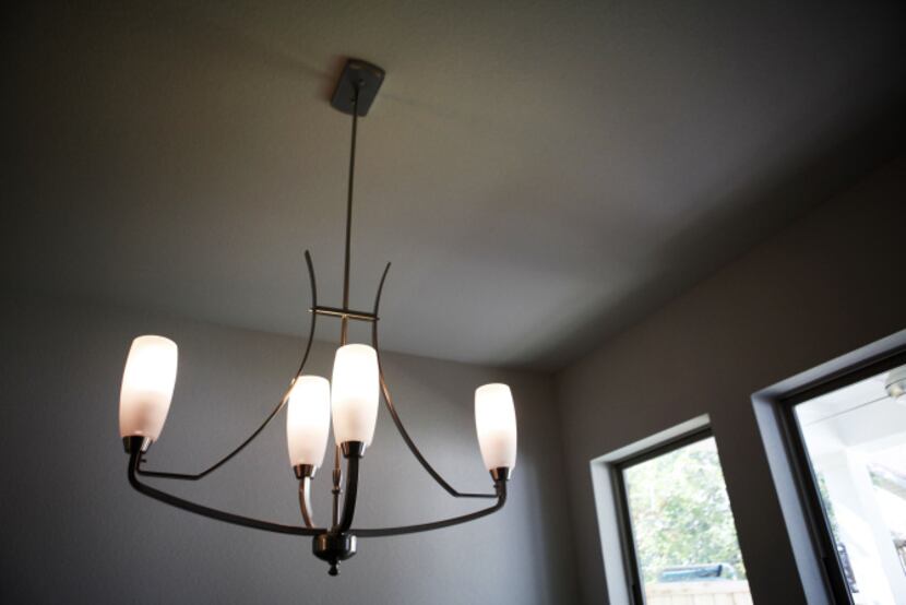 Compact fluorescent light bulbs are an eco-friendly feature at a Greenbrook Homes house on...