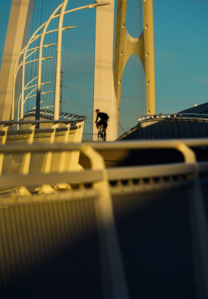 A cyclist attempts to ride up the pedestrian and bike portion of the Margaret McDermott...