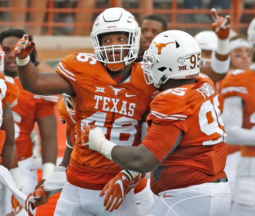 Texas linebacker Malik Jefferson (46) and defensive tackle Poona Ford (95) celebrate a...