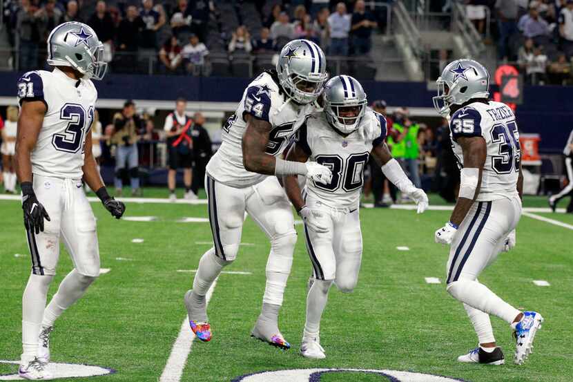 Dallas Cowboys cornerback Anthony Brown (30) is congratulated by teammate outside linebacker...