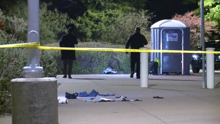Officers investigate the aftermath of a fatal shooting at TRE's CentrePort/DFW Airport...