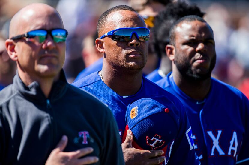 Texas Rangers third baseman Adrian Beltre (29, center) and other players stand for the...