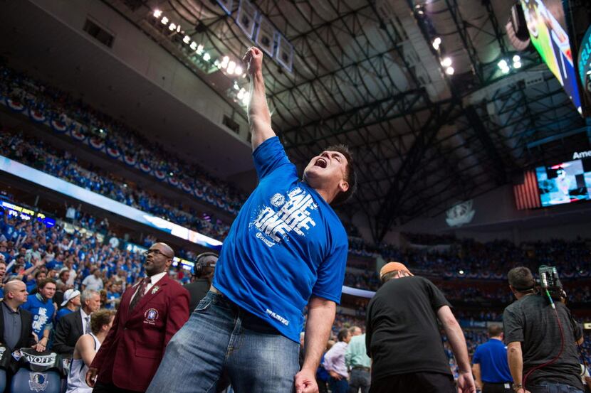 Dallas owner Mark Cuban stands by the Larry O'Brien trophy before the Miami Heat vs. the...