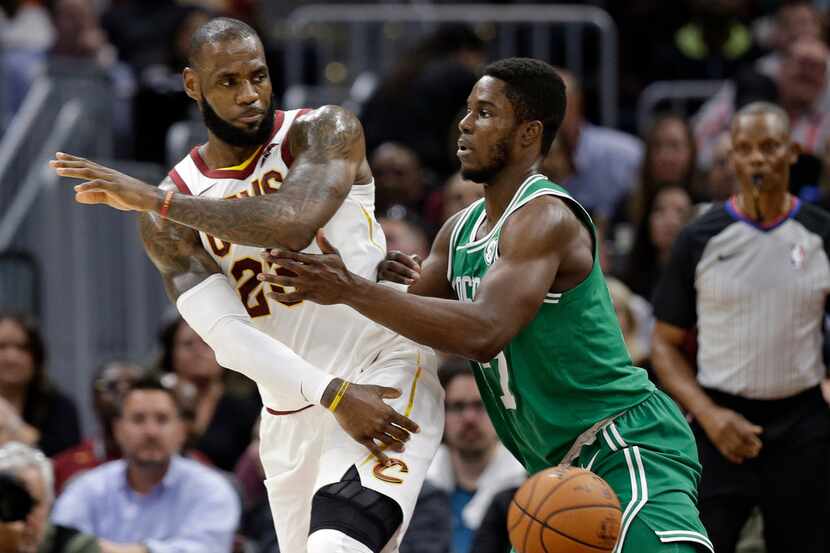 Cleveland Cavaliers' LeBron James, left, passes against Boston Celtics' Semi Ojeleye in the...