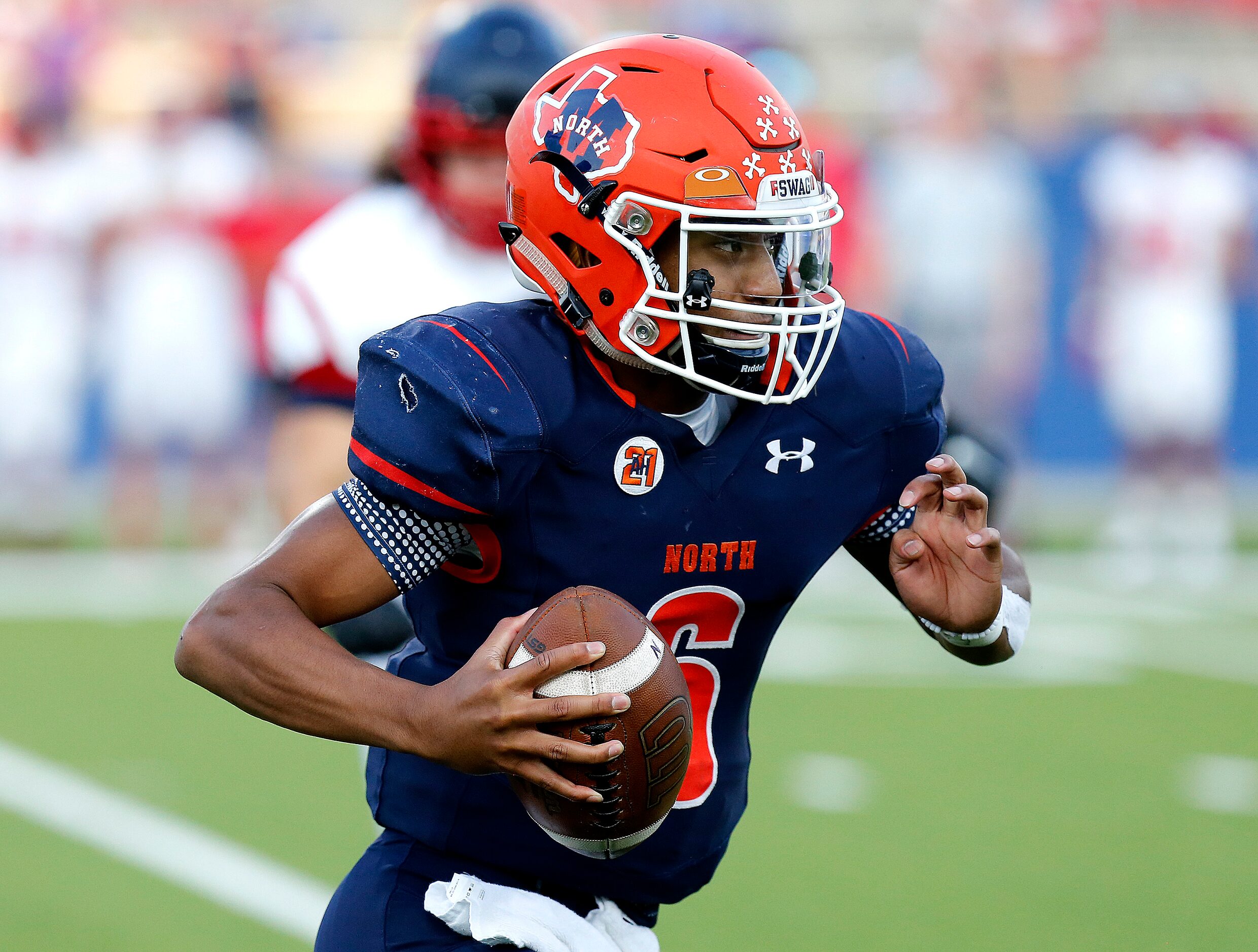 McKinney North High School quarterback Gavin Constantine ll (6) scrambles for yardage during...