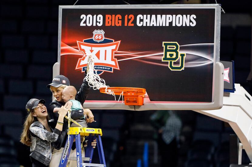 Baylor head coach Kim Mulkey holds her grandson, assisted by her daughter Makenzie Fuller,...