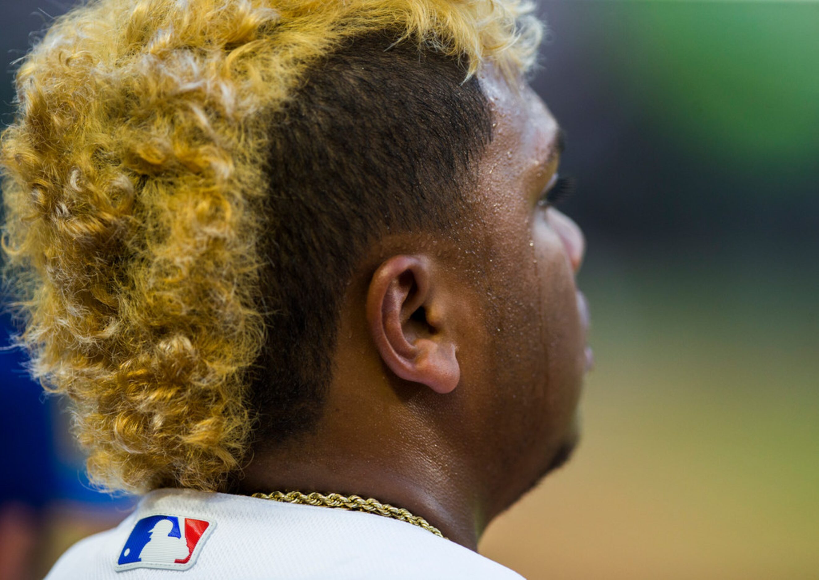 Texas Rangers left fielder Willie Calhoun (5) sweats in the dugout during the fourth inning...