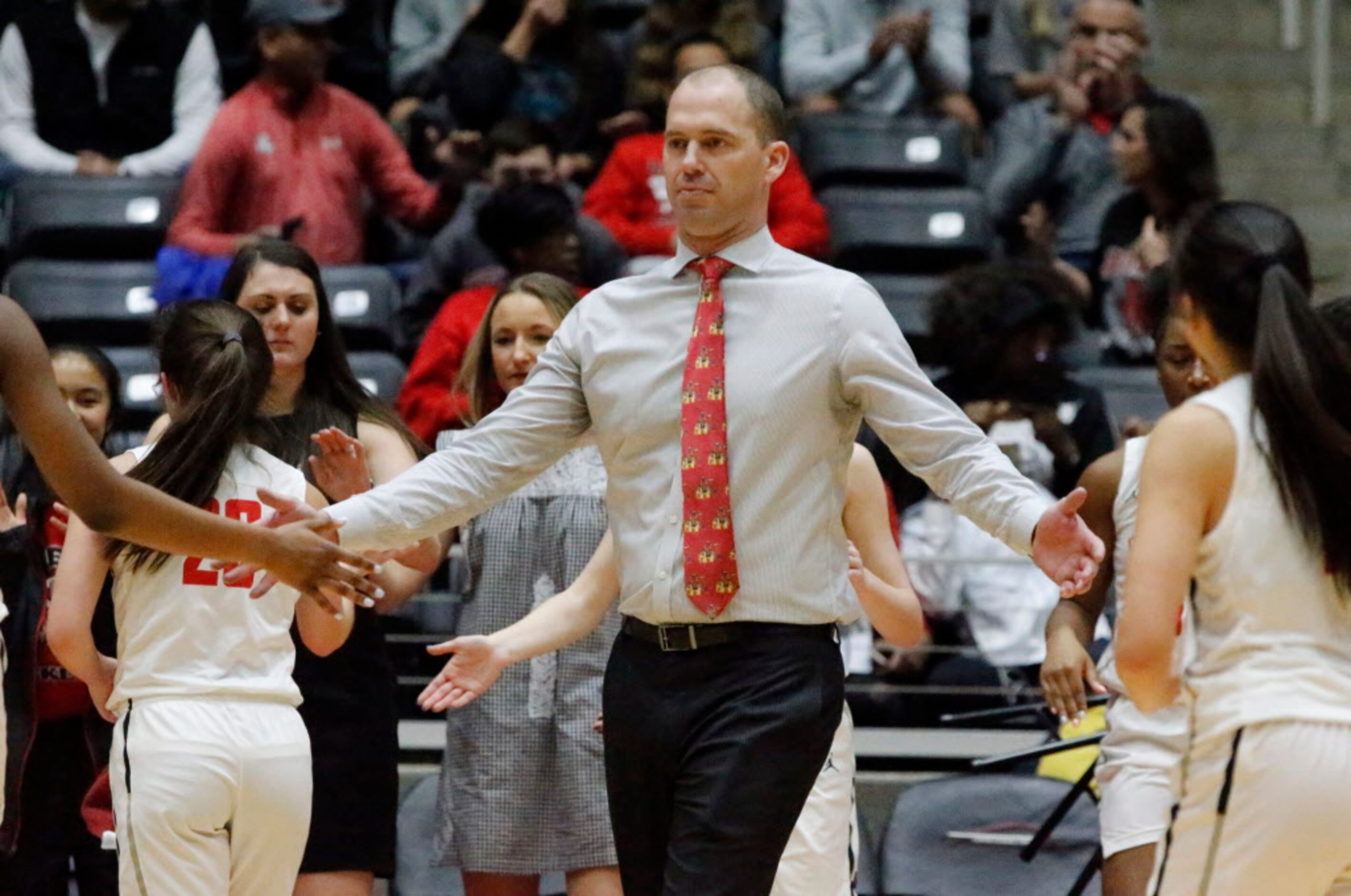 Liberty High School head coach Ross Reedy congratulates his team as they get the momentum...