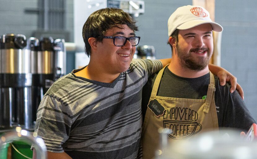 Spencer Khan (left) and William Mullican speak to costumers as the workday ends at...