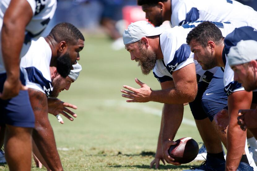 Dallas Cowboys center Travis Frederick (72) snaps the ball during the morning walk-through...