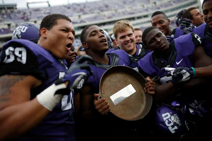 TCU players pose for photos with the Iron Skillet. (Garett Ray Fisbeck/The Dallas Morning News)