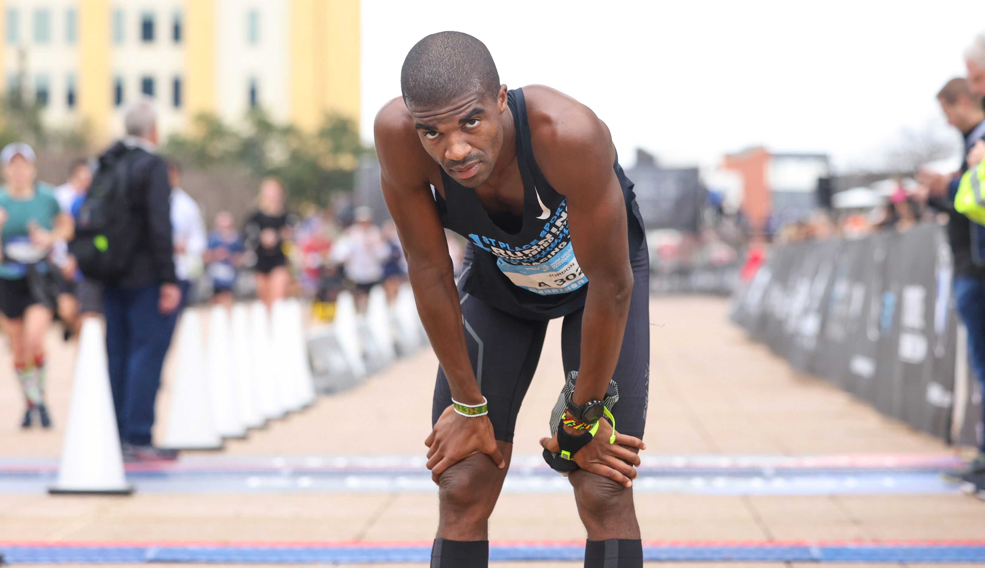 Marathon runner Jordon Garman looks up after stopping to catch his breath at the finish line...