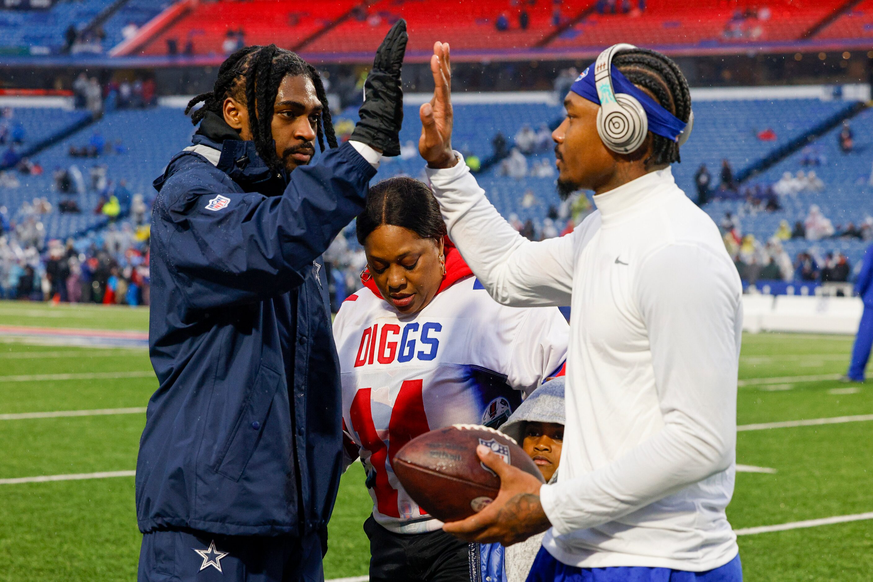 Dallas Cowboys cornerback Trevon Diggs (left) high-fives his brother and Buffalo Bills wide...