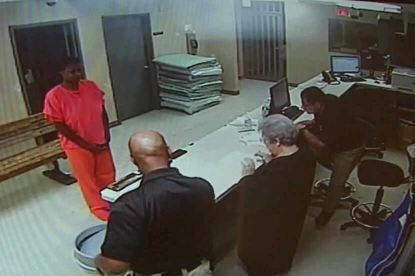  Sandra Bland stands before a desk at Waller County Jail in Hempstead. (File/Waller County...