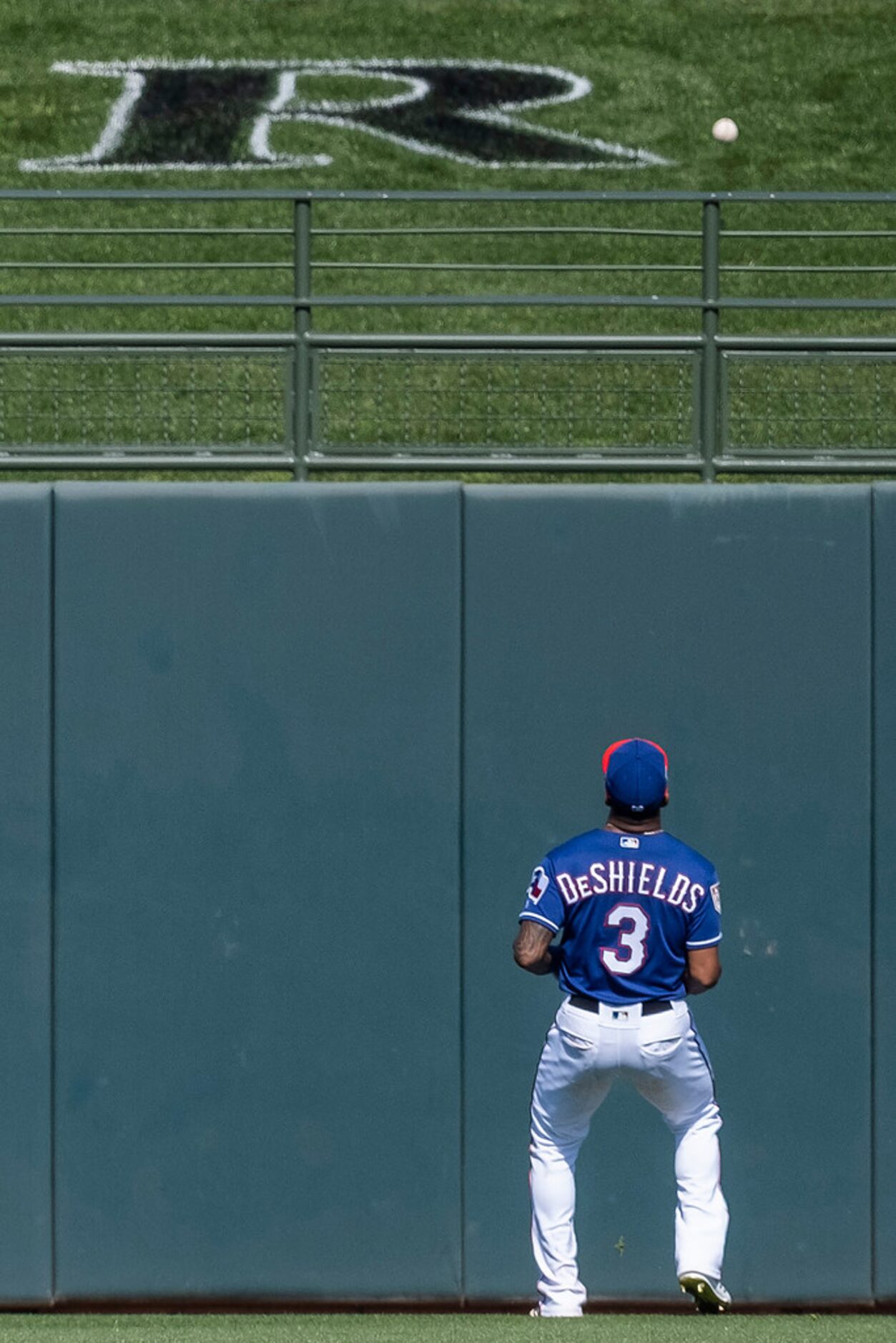 Texas Rangers outfielder Delino DeShields watches a 2-run home run off the bat of Chicago...