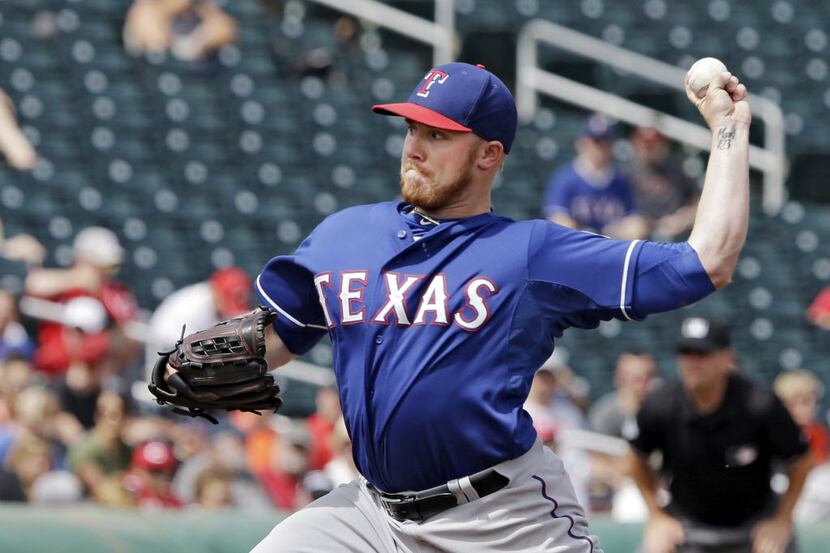 Texas Rangers pitcher Robbie Ross delivers against the Cincinnati Reds in the first inning...